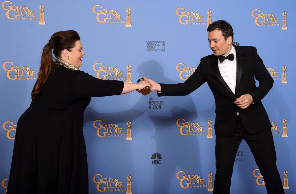 Melissa McCarthy, left, and Jimmy Fallon pose in the press room at the 71st annual Golden Globe Awards at the Beverly Hilton Hotel on Sunday, Jan. 12, 2014, in Beverly Hills, Calif. (Photo by Jordan Strauss/Invision/AP)