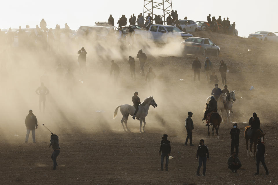 Bedouin protesters clash with Israeli forces following a protest against an afforestation project by the Jewish National Fund in the southern Israeli village of Sa'we al-Atrash in the Negev Desert, southern Israel, Thursday, Jan. 13, 2022. (AP Photo/Tsafrir Abayov)