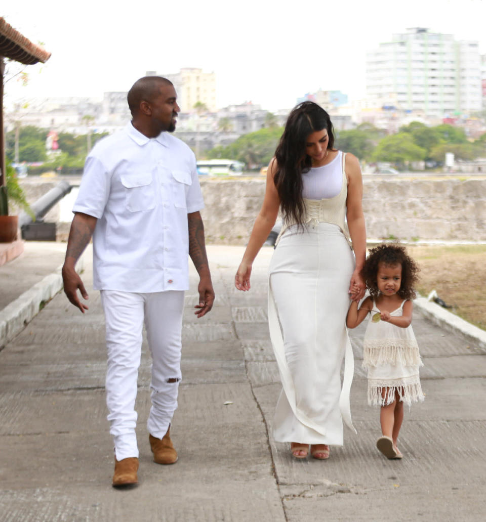 <p>Cuba is so hot right now, and the Kardashian-West clan just affirmed it. While in Havana, Kanye, Kim and North — sans Saint — stepped out for a stroll, in coordinated variations of white. While Yeezy opted for the crispest shade, Kim and Nori donned cream-colored dresses. North, who gave up her tried and true top knot for loose curls, was on trend in a fringed frock and nude flats. Photo: Splash News </p>