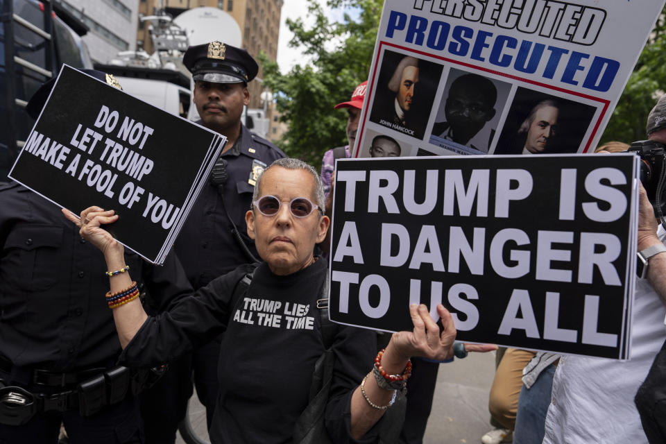 Police officers escort an anti-Trump protester from Collect Pond Park outside Manhattan Criminal Court, Thursday, May 30, 2024, in New York. (AP Photo/Julia Nikhinson)