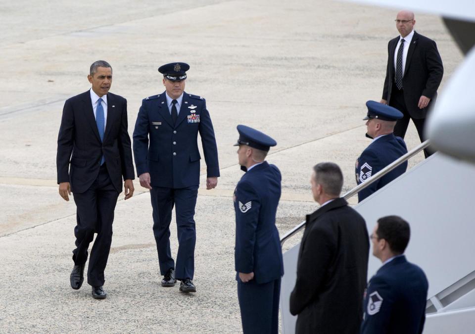 President Barack Obama prepares to board Air Force One at Andrews Air Force Base, Md., Wednesday, April 2, 2014, en route to the University of Michigan to speak about his proposal to raise the national minimum wage. (AP Photo/Carolyn Kaster)