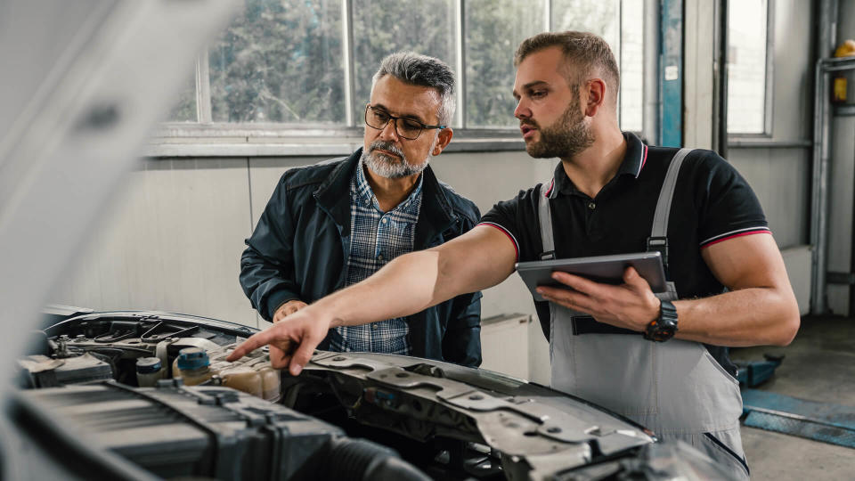 Auto mechanic with customer.