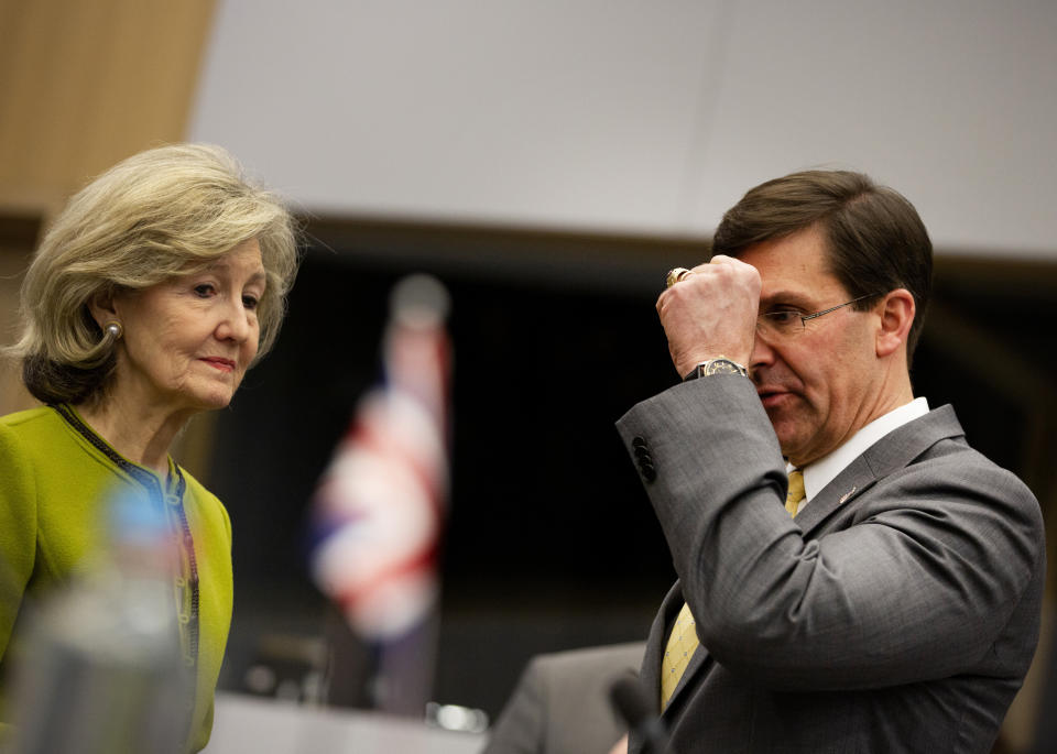 U.S. Secretary for Defense Mark Esper, right, speaks with U.S. Ambassador to NATO Kay Bailey Hutchison during a meeting of the Resolute Support Mission at NATO headquarters in Brussels, Thursday, Feb. 13, 2020. NATO ministers, in a second day of meetings, will discuss building stability in the Middle East, the Alliance's support for Afghanistan and challenges posed by Russia's missile systems. (AP Photo/Virginia Mayo)