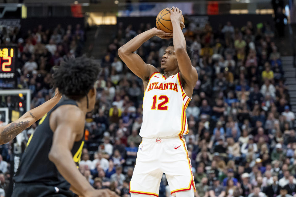 Atlanta Hawks forward De'Andre Hunter (12) shoots during the first half of an NBA basketball game against the Utah Jazz, Friday, March 15, 2024, in Salt Lake City. (AP Photo/Spenser Heaps)