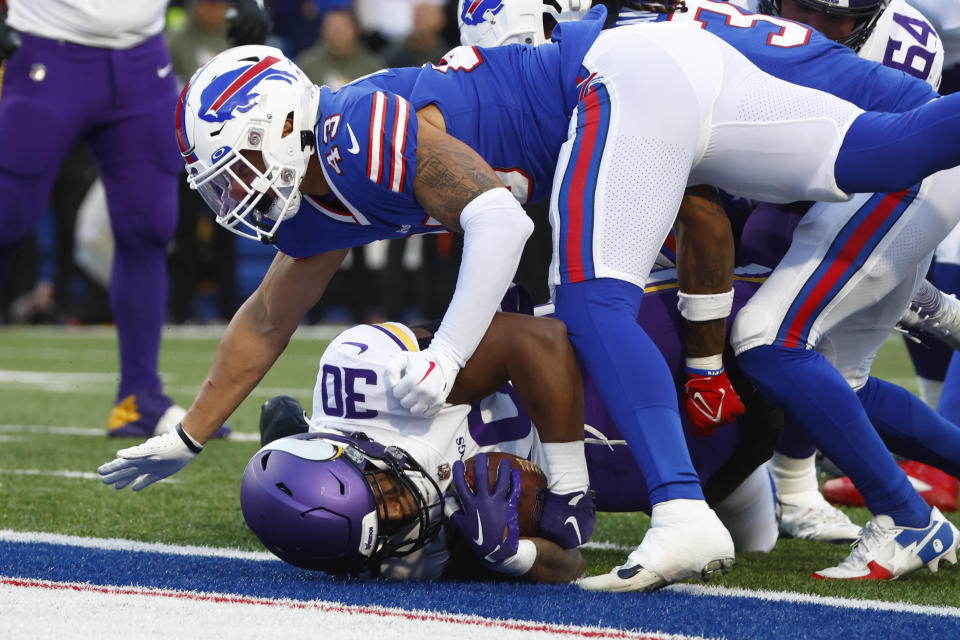 Minnesota Vikings fullback C.J. Ham (30) enters the end zone for a touchdown as Buffalo Bills linebacker Terrel Bernard (43) tries to defend in the second half of an NFL football game, Sunday, Nov. 13, 2022, in Orchard Park, N.Y. (AP Photo/Jeffrey T. Barnes)