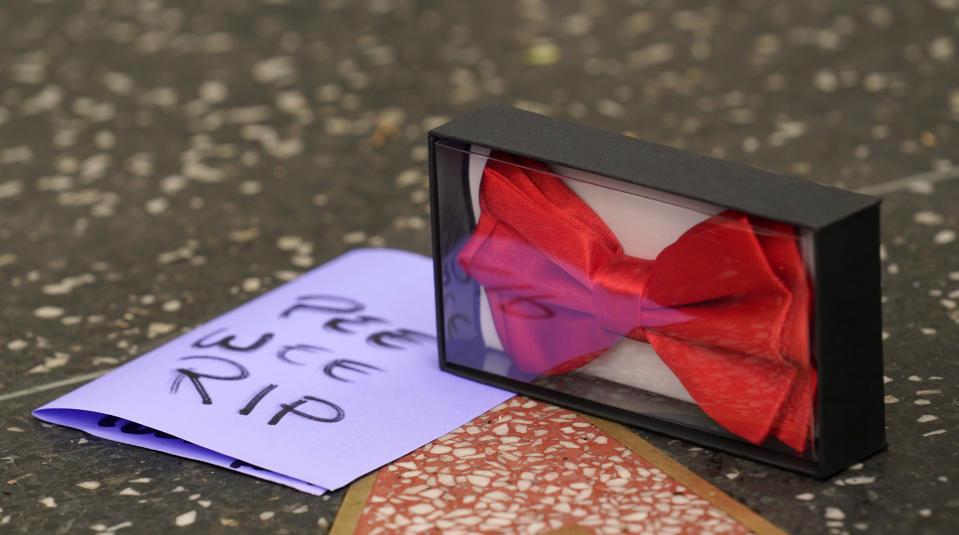 A red bow tie sits near the star of Pee-wee Herman on the Hollywood Walk of Fame, Monday, July 31, 2023, in Los Angeles. Paul Reubens, the actor and comedian who created the Pee-wee Herman character, died Sunday night after a six-year struggle with cancer. (AP Photo/Chris Pizzello)