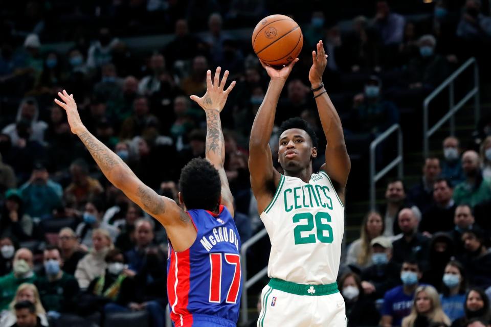 Boston Celtics' Aaron Nesmith (26) shoots over Detroit Pistons' Rodney McGruder (17) during the first half of an NBA basketball game, Wednesday, Feb. 16, 2022, in Boston.