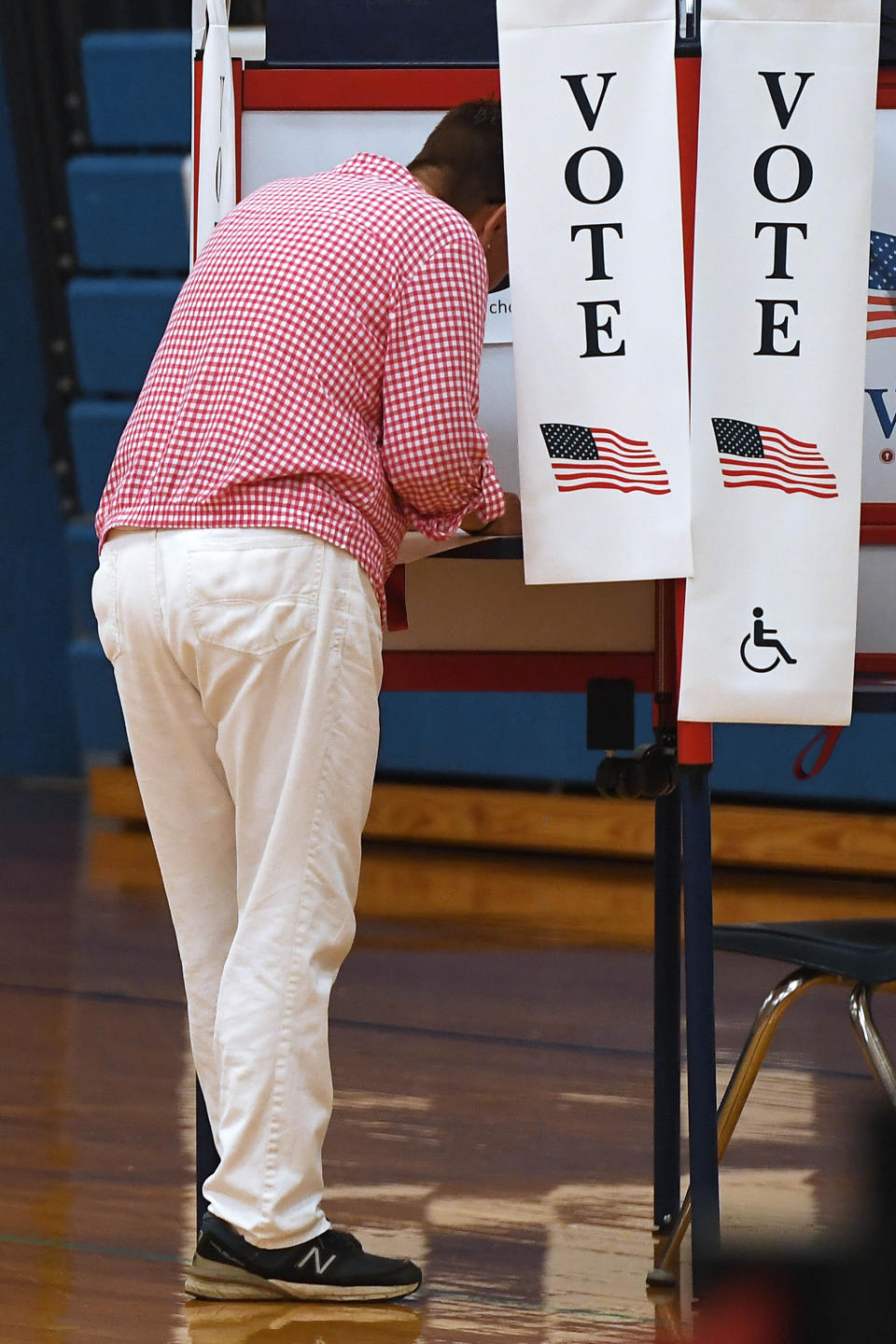 A voter casts a ballot on on primary election day, Tuesday, Aug. 9, 2022, in Suffield, Conn. Suffield is one of several small towns in Connecticut where control was flipped from Democrats to Republicans in 2021 municipal races. (AP Photo/Jessica Hill)