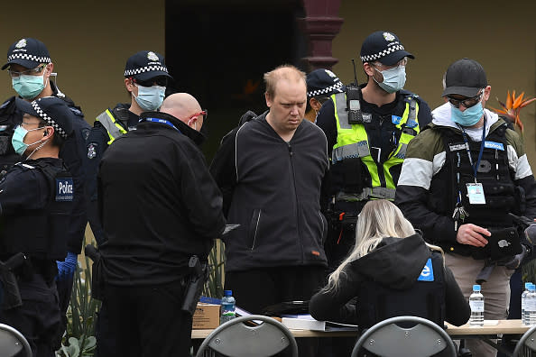 Police detain a protester during an anti-lockdown rally in Melbourne.