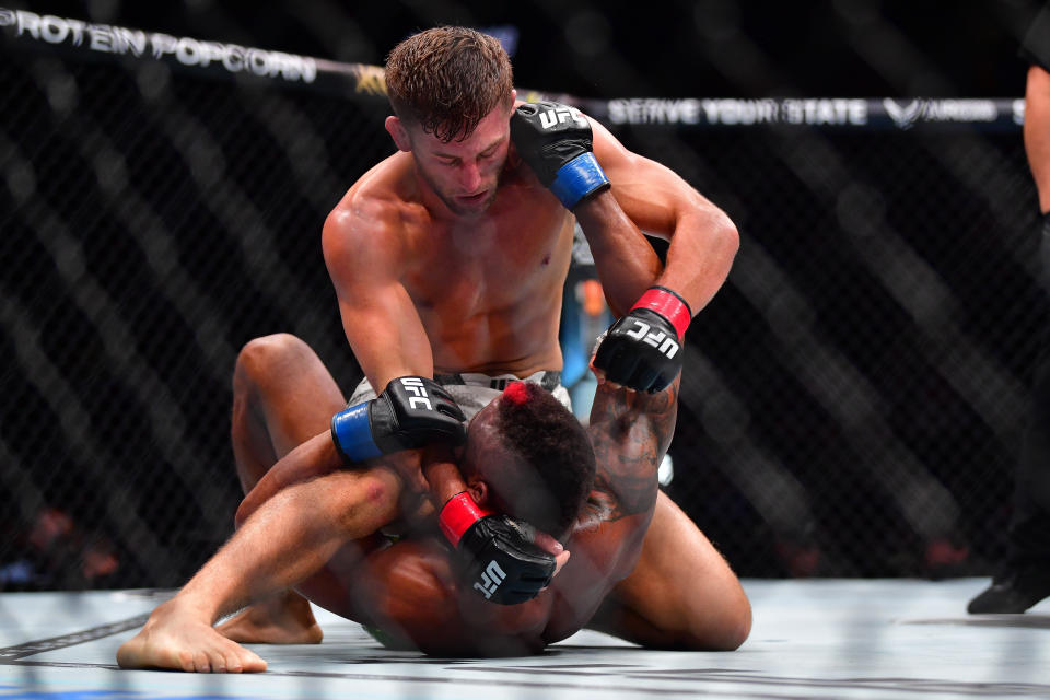 Feb 17, 2024; Anaheim, California, USA; Oban Elliott pins Val Woodburn to the mat during UFC 298 at Honda Center. Mandatory Credit: Gary A. Vasquez-USA TODAY Sports