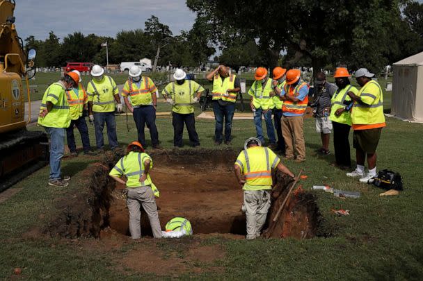 PHOTO: Archaeologists and researchers examine a hole that was dug during a test excavation of the possible 1921 Tulsa Race Massacre Graves at Oaklawn Cemetery in Tulsa, Oklahoma on July 13, 2020. (Nick Oxford for The Washington Post via Getty Images, FILE)