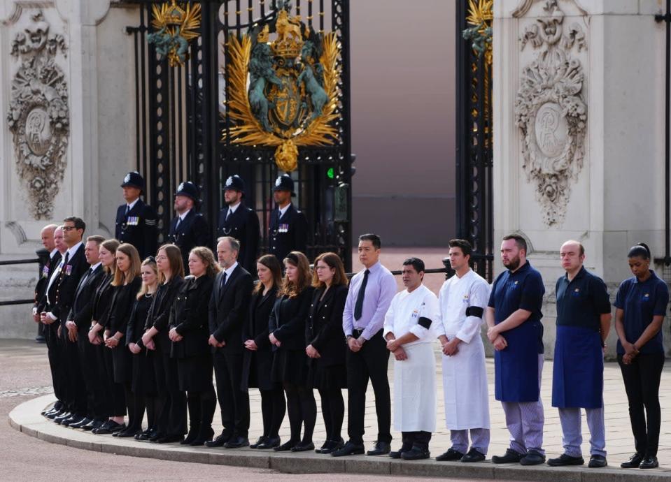Buckingham Palace household staff pay their respects during the coffin procession from Westminster Abbey to Wellington Arch (Carl Court/PA) (PA Wire)