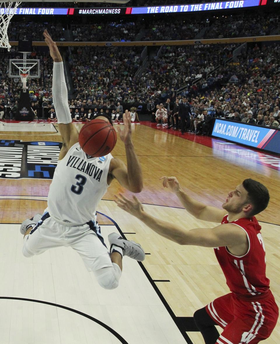 <p>Villanova guard Josh Hart (3) loses control of the ball while driving to the basket against Wisconsin guard Zak Showalter (3) during the first half of a second-round men’s college basketball game in the NCAA Tournament, Saturday, March 18, 2017, in Buffalo, N.Y. (AP Photo/Bill Wippert) </p>