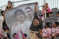 Fans raise a banner of Lionel Messi and Diego Maradona during the first half of a Leagues Cup soccer match between Inter Miami and Cruz Azul, Friday, July 21, 2023, in Fort Lauderdale, Fla. (AP Photo/Rebecca Blackwell)