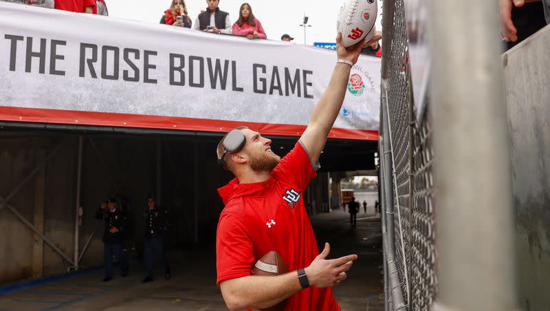 Utah Utes tight end Brant Kuithe (80) hands a fan a signed ball before Utah played the Penn Sate Nittany Lions in the 109th Rose Bowl in Pasadena on Jan. 2, 2023.