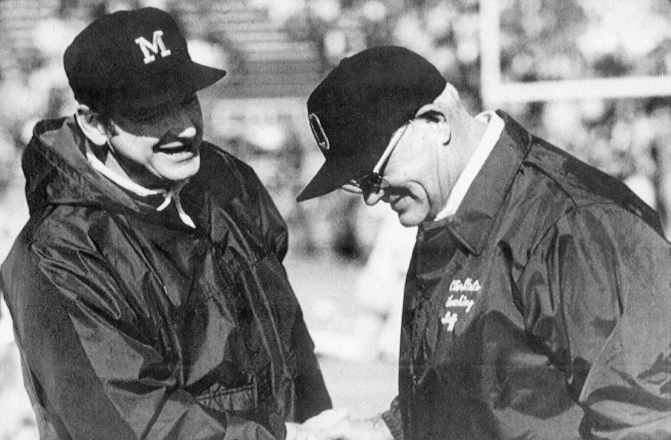 ** FILE ** Michigan football coach Bo Schembechler, left, meets with Ohio State coach Woody Hayes in this undated file photo, location unknown. The teams they coached will meet for the 100th time on Saturday, Nov. 22, 2003, and the ten games featuring Hayes and Schembechler are remembered as the highlight of the series. The Buckeyes or Wolverines were in the Rose Bowl each year the two legendary coaches dueled for a win in one of college football's greatest rivalries from 1969-78. (AP Photo)