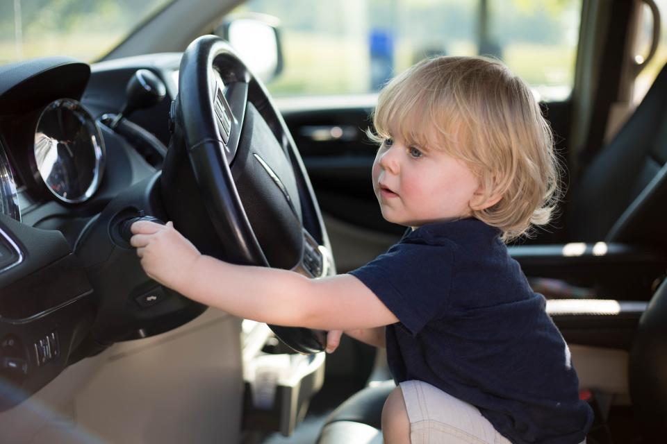 Renly Andreasen is shown playing in the driver's seat of a car in 2020.