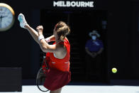 Aryna Sabalenka of Belarus attempts a return shot to Wang Xinyu of China during their second round match at the Australian Open tennis championships in Melbourne, Australia, Thursday, Jan. 20, 2022. (AP Photo/Hamish Blair)