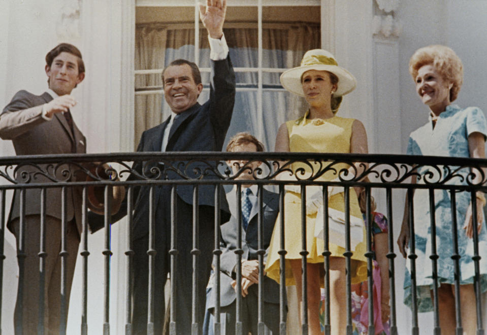 FILE - President Richard Nixon waves from the balcony of the Executive Mansion as he and first lady Pat Nixon, right, pose with Britain's Prince Charles, left, and Princess Anne of Britain, July 16, 1970. (AP Photo, File)