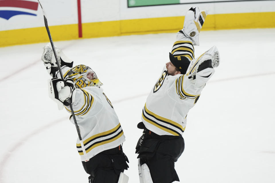 Boston Bruins goaltender Jeremy Swayman, left, and goaltender Linus Ullmark, right, celebrate after defeating the Toronto Maple Leafs in Game 4 of an NHL hockey Stanley Cup first-round playoff series in Toronto, Saturday, April 27, 2024. (Nathan Denette/The Canadian Press via AP)