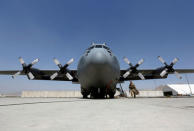 A U.S. soldier boards an Afghan Air Force C-130 military transport plane before flight in Kabul, Afghanistan July 9, 2017. REUTERS/Omar Sobhani