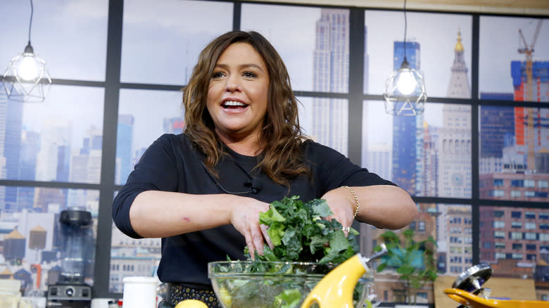 Rachael Ray mixing salad greens