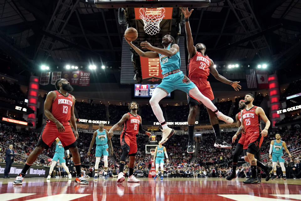 Memphis Grizzlies' Josh Jackson (20) goes up for a shot as Houston Rockets' Jeff Green (32) defends during the first half of an NBA basketball game Wednesday, Feb. 26, 2020, in Houston. (AP Photo/David J. Phillip)