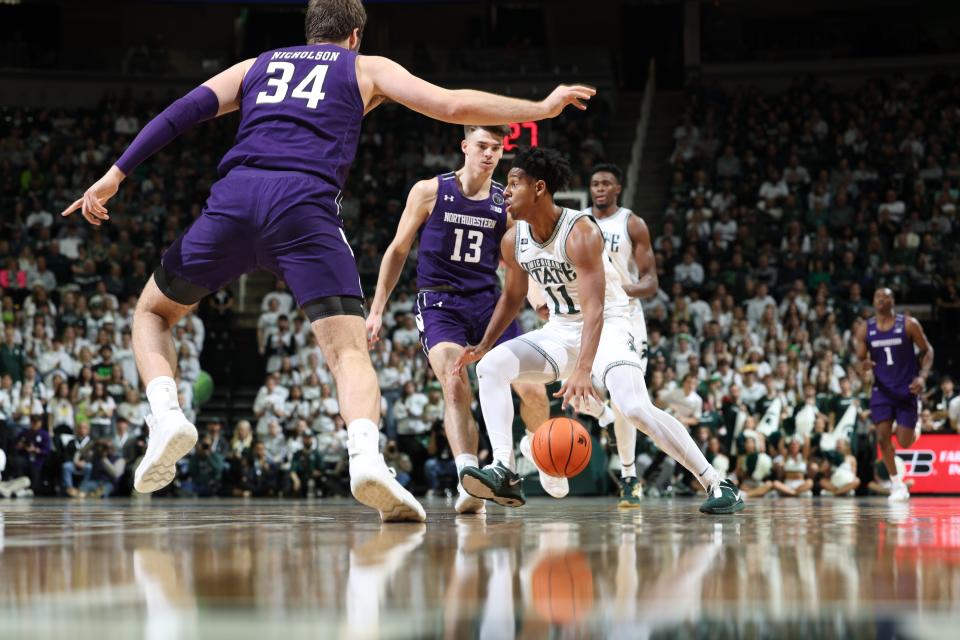 A.J. Hoggard (11) of the Michigan State Spartans handles the ball against the Northwestern Wildcats in the first half of the game at Breslin Center on December 4, 2022 in East Lansing, Michigan.