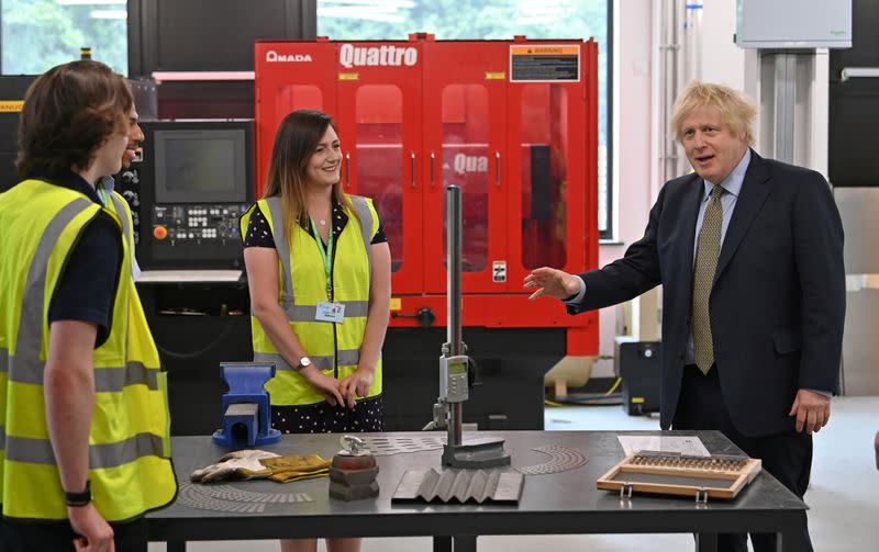 Britain's Prime Minister Boris Johnson gestures as he speaks with construction apprentices at The Dudley Institute of Technology in Dudley