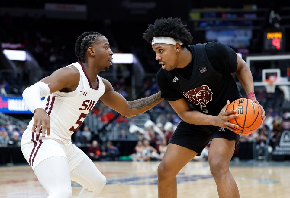 Missouri State's Donovan Clay (5) moves the ball defended by Southern Illinois' Lance Jones (5)during a Missouri Valley Conference Tournament game, Friday, March 3, 2023, at Enterprise Center in St. Louis. 