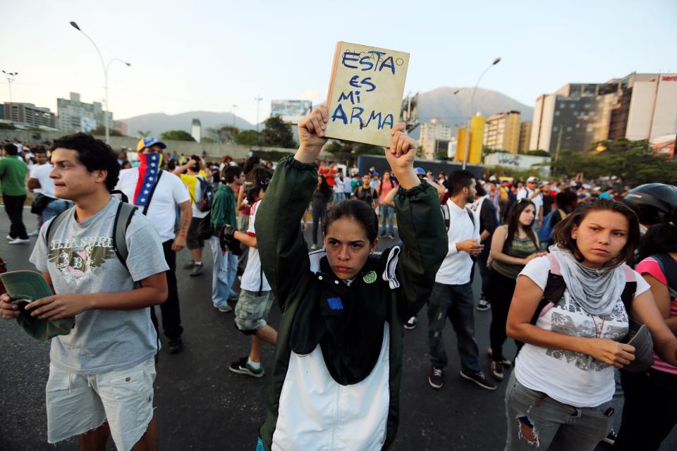 Manifestación en Caracas, 13 de febrero de 2014, contra la violenta represión de los estudiantes el día anterior. Entre rumores de represión, el gobierno y la oposición se culparon mutuamente por los choques de la víspera, cuando partidarios del gobierno arribaron en motos y dispararon a un grupo de manifestantes que habían chocado con la policía.(AP Foto/Fernando Llano)