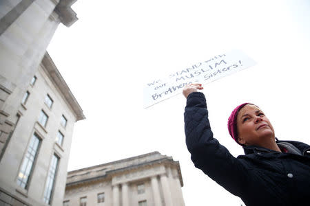 Immigration activists, including members of the DC Justice for Muslims Coalition, rally against the Trump administration's new ban against travelers from six Muslim-majority nations, outside of the U.S. Customs and Border Protection headquarters in Washington, U.S., March 7, 2017. REUTERS/Eric Thayer