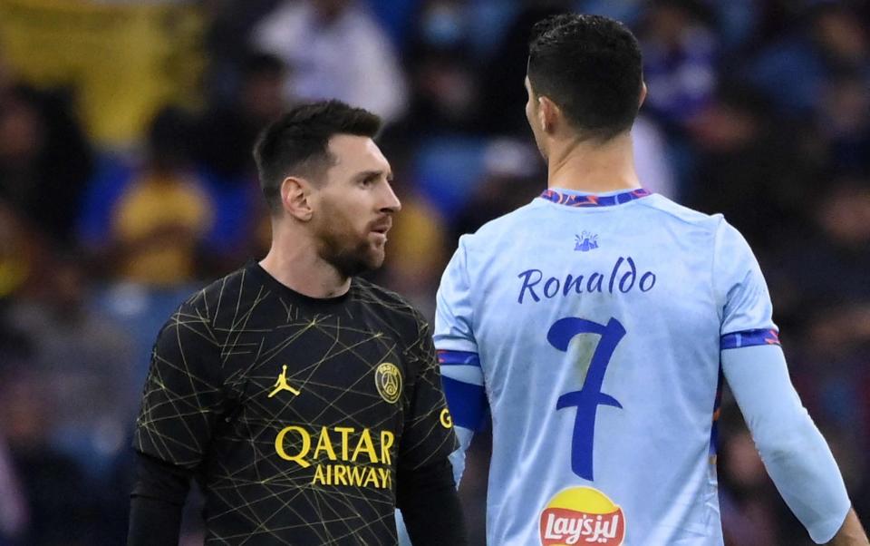 El delantero argentino del Paris Saint-Germain, Lionel Messi (izquierda), pasa junto al delantero portugués del Riyadh All-Star, Cristiano Ronaldo - AFP/Franck Fife