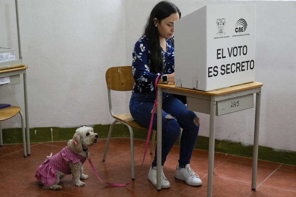 A voter marks her ballot during a referendum proposed by President Daniel Noboa to endorse new security measures aimed at crack down on criminal gangs fueling escalating violence, in Quito, Ecuador, April 21, 2024. (AP Photo/Dolores Ochoa)
