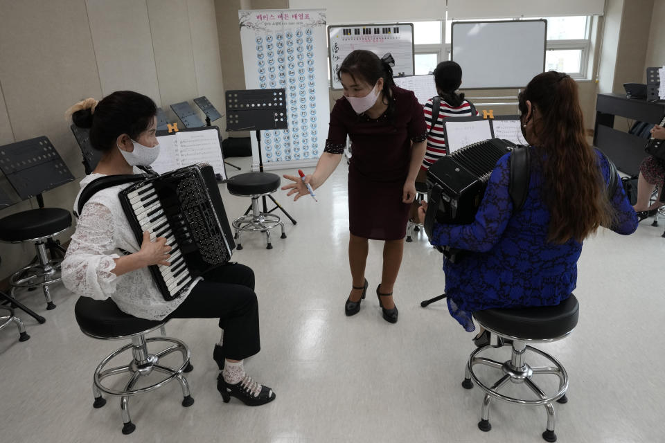 Ko Jeong Hee, center, a defector who teaches accordion, talks with another defector Yu Hwa-suk, left, during the accordion class at the Inter-Korean Cultural Integration Center in Seoul, South Korea, on June 10, 2021. The center, which opened last year, is South Korea’s first government-run facility to bring together North Korean defectors and local residents to get to know each other through cultural activities and fun. It’s meant to support defectors’ often difficult resettlement in the South, but also aims at studying the possible blending of the rivals’ cultures should they unify. (AP Photo/Ahn Young-joon)