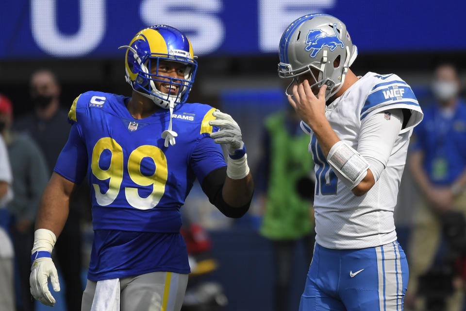 Detroit Lions quarterback Jared Goff, right, talks with Los Angeles Rams defensive end Aaron Donald during the first half of an NFL football game Sunday, Oct. 24, 2021, in Inglewood, Calif. (AP Photo/Kevork Djansezian)