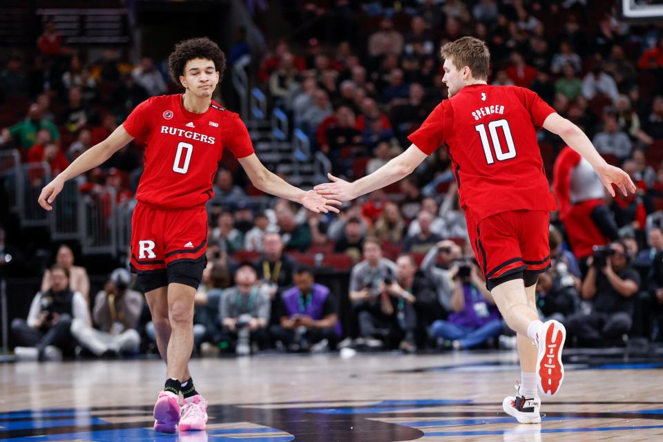 Mar 10, 2023; Chicago, IL, USA; Rutgers Scarlet Knights guard Cam Spencer (10) is congratulated by guard Derek Simpson (0) after scoring against the Purdue Boilermakers during the first half at United Center. Mandatory Credit: Kamil Krzaczynski-USA TODAY Sports