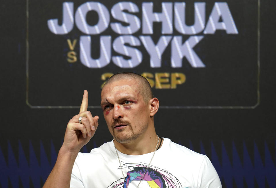 Oleksandr Usyk of Ukraine gestures during a press conference after winning the WBA (Super), WBO and IBF boxing title bout against Anthony Joshua of Britain at the Tottenham Hotspur Stadium in London Saturday Sept. 25, 2021. (Nick Potts/PA via AP)