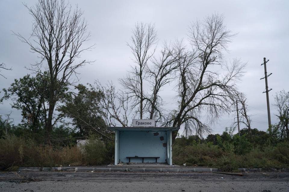 A bus stop damaged from shrapnel is seen on the road at the entrance of the freed village of Hrakove, Ukraine, Tuesday, Sept. 13, 2022. Russian troops occupied this small village southeast of Ukraine’s second largest city of Kharkiv for six months before suddenly abandoning it around Sept. 9 as Ukrainian forces advanced in a lightning-swift counteroffensive that swept southward. (AP Photo/Leo Correa)