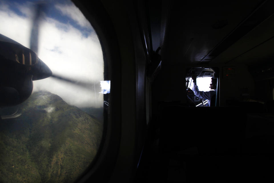 In this Friday, May 24, 2013 photo, a flight approaches Lukla airport, Nepal. Carved out of the side of a mountain, the airport was built by Sir Edmund Hillary in 1965, and at an altitude of 2,843 meters (9,325 feet) it has earned the reputation of being one of the most extreme and dangerous airports in the world. (AP Photo/Niranjan Shrestha)