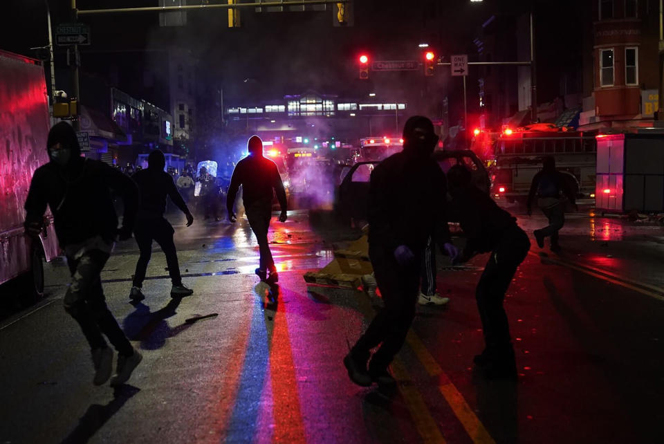 People gather in protest in response to the police shooting of Walter Wallace Jr., early Tuesday, Oct. 27, 2020, in Philadelphia. Police officers fatally shot the 27-year-old Black man during a confrontation Monday afternoon in West Philadelphia that quickly raised tensions in the neighborhood. (Jessica Griffin/The Philadelphia Inquirer via AP)