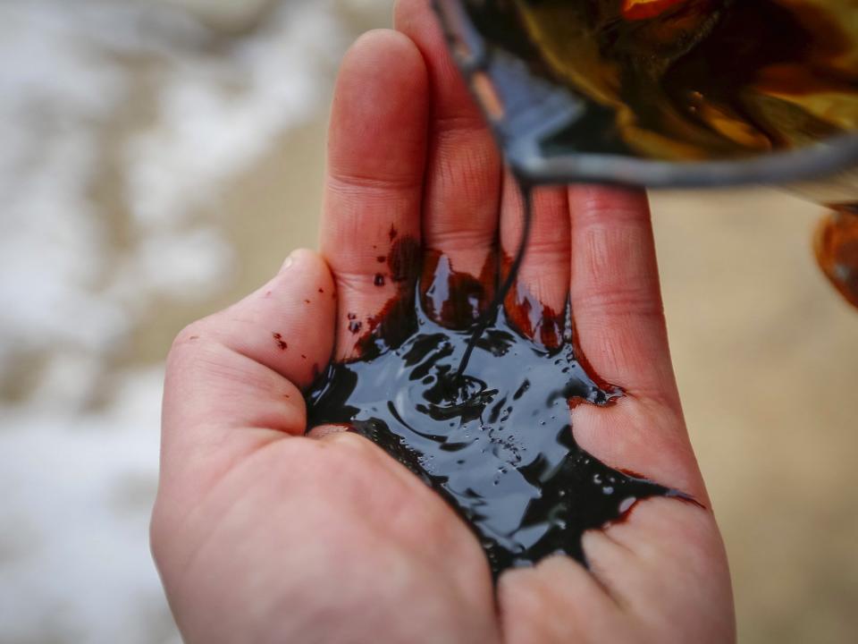 A picture illustration shows oil being poured on a palm at an oil field operated by a subsidiary of the KazMunayGas Exploration Production JSC in Kyzylorda region, southern Kazakhstan, January 22, 2016. Picture taken January 22, 2016.