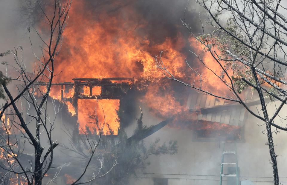 The Mountain Fire burns a home off Bear Mountain Road in Jones Valley northeast of Redding on Thursday, Aug. 22, 2019.