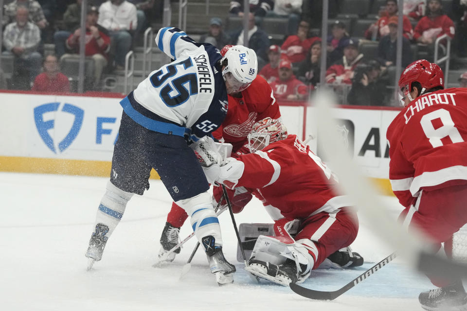Detroit Red Wings goaltender James Reimer (47) stops a shot by Winnipeg Jets center Mark Scheifele (55) during the first period of an NHL hockey game, Thursday, Oct. 26, 2023, in Detroit. (AP Photo/Carlos Osorio)
