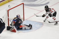 Canada's Marie-Philip Poulin (10) scores a goal against United States goaltender Nicole Hensley during the first period of a women's hockey game in a pre-Olympic Games series Monday, Oct. 25, 2021, in Hartford, Conn. (AP Photo/Jessica Hill)