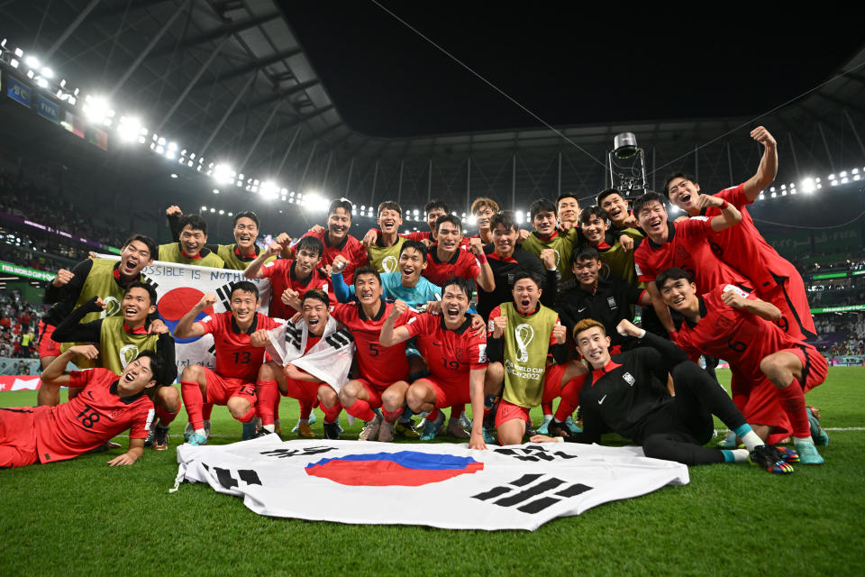 AL RAYYAN, QATAR - DECEMBER 02: Korea Republic players celebrate after the team's qualification to the knockout stages during the FIFA World Cup Qatar 2022 Group H match between Korea Republic and Portugal at Education City Stadium on December 02, 2022 in Al Rayyan, Qatar. (Photo by Shaun Botterill - FIFA/FIFA via Getty Images)