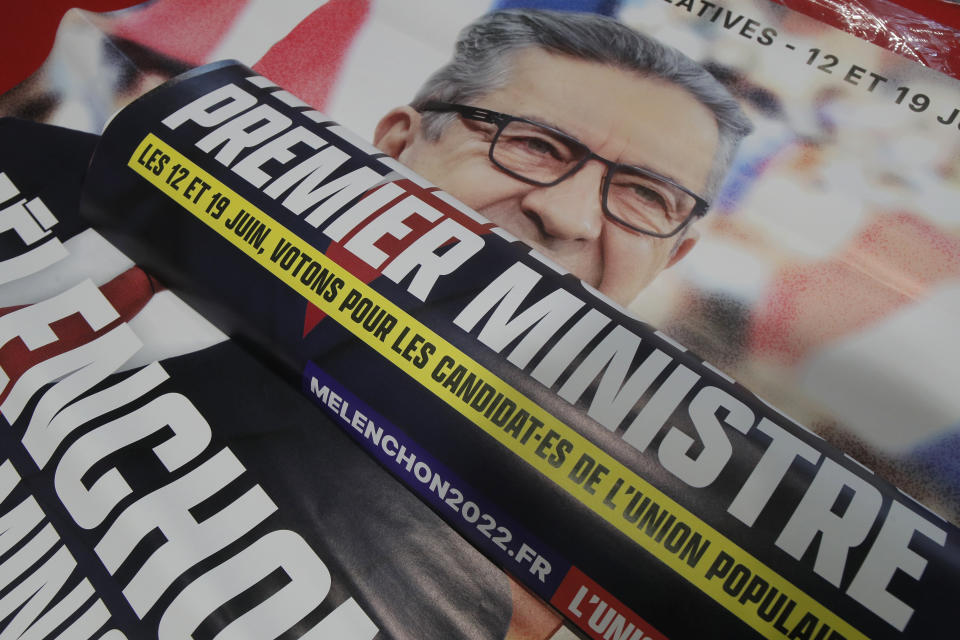 Electoral posters for far-left leader Jean-Luc Melencho and reading "Melenchon Prime Minister" are pictured before a local meeting, Thursday, May 5, 2022 in Lille, northern France. Jean-Luc Melenchon, who earned a third place finish in the presidential election, is trying to engineer a stunning comeback as the head of a coalition of leftist parties who have spent the past five years in the president's large shadow. Legislative elections will be held over two rounds of voting, on June 12 and 19.(AP Photo/Michel Spingler)