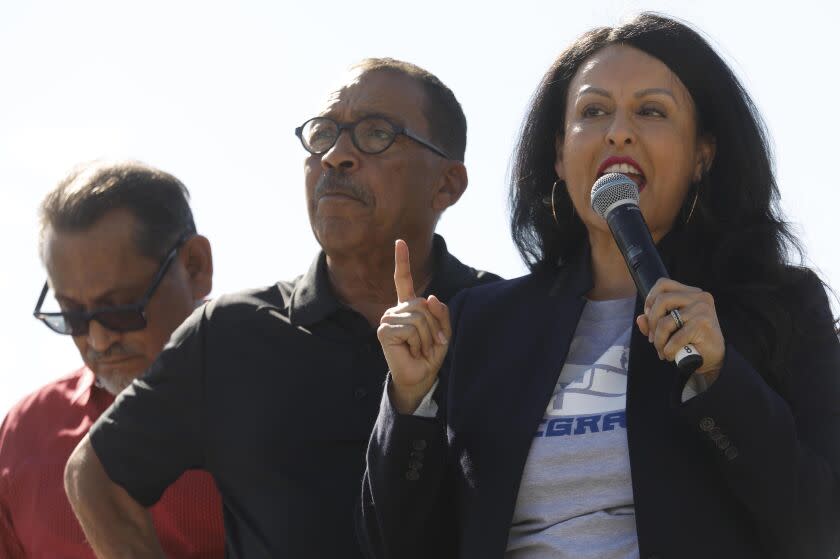 LOS ANGELES, CA - NOVEMBER 9, 2019 - - Los Angeles City Council Member Nury Martinez, right, addresses the crowd as Los Angeles City Council President Herb Wesson, center, and Los Angeles City Council member Gil Cedillo listen at the, "Rally for Justice Immigrant Rights and Equality - 25 years beyond Proposition 187," at the Los Angeles State Historic Park in Los Angeles on November 9, 2019. Prop. 187 aimed to block undocumented immigrants from using non-emergency health care, public education and other services in the State of California. Federal courts denied it from ever being implemented. Congresswoman Lucille Roybal Allard, Los Angeles Mayor Eric Garcetti, and many other politicians and activists spoke at the rally. (Genaro Molina / Los Angeles Times)