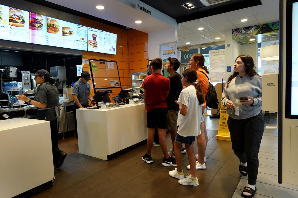 MIAMI, FLORIDA - JULY 26: Customers wait to order food at a  McDonalds fast food restaurant on July 26, 2022 in Miami, Florida. The McDonald's company reported U.S. same-store sales rose 3.7%, while international sales rose 9.7% during the most recent quarter. However, it also said that total revenue fell 3% to $5.72 billion; it attributed the weakness to slowing demand in China. (Photo by Joe Raedle/Getty Images)