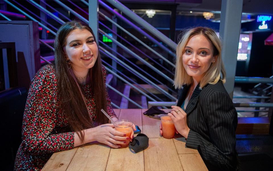 Students Hannah Ward, 18, (Glasgow University) (L) and first year University of Glasgow student Jenijo MacFarlane, 18, (R) inside Firewater nightclub/bar on the famous Sauchiehall Street, Glasgow, which was much quieter than usual. September 25, 2020. Firewater usually closes at 3am - James Chapelard 